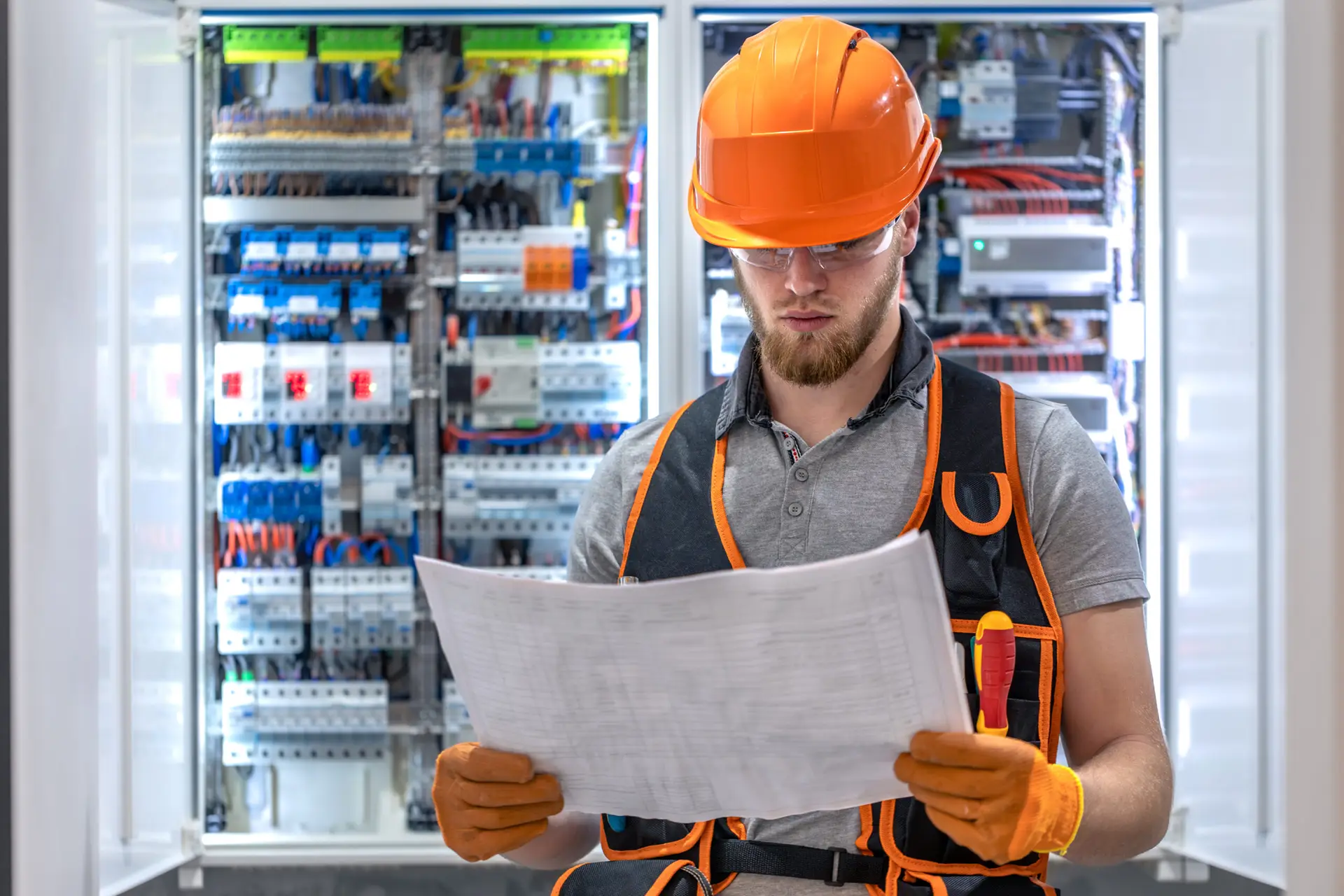 Male construction worker in overalls. Male electrician in overalls.